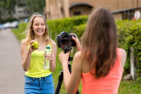 Two Girls Are Girlfriends Summer In Nature Writes Video To Camera In Her Hands Holds Bottle