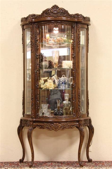 This transitional curved glass curio cabinet features four curved front glass doors with nickel finished hardware. SOLD - Carved Fruitwood Curved Glass Curio Display Cabinet ...