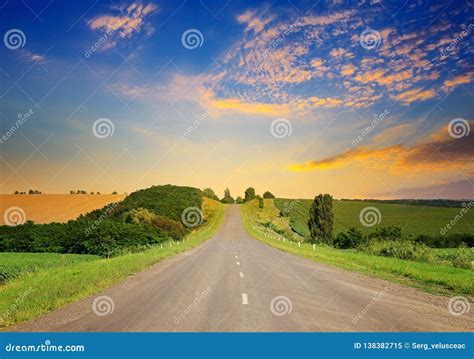 Sunrise Over Picturesque Landscape Straight Road And Fields Stock