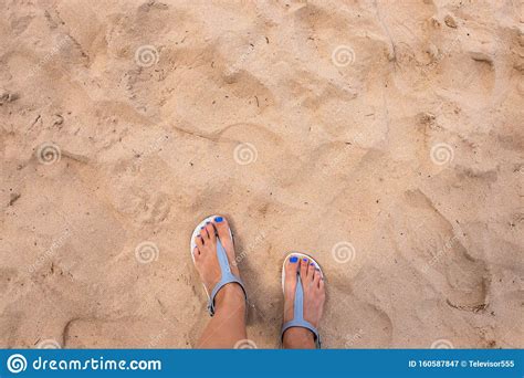 Beach Sand And Woman Feet Top View Girl Feet In Sandal On Hot Sandy