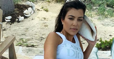 kourtney kardashian flaunts peachy bum as she strips for bottomless snap on beach daily star