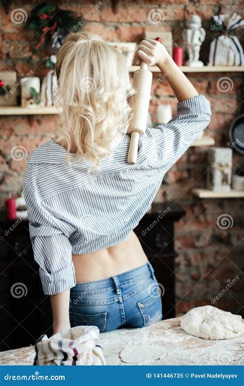Young Woman Blonde Erotic Stands With Her Back And Prepares Dough In