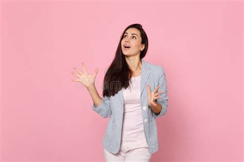 Portrait Of Excited Beautiful Young Woman In Striped Jacket Spreading Hands Fingers Looking Up
