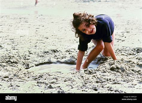 Girl Digging Hole In Sand Stock Photo Alamy