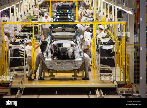 Automobile Industry Workers Assembly Line At Nissan Resende Factory