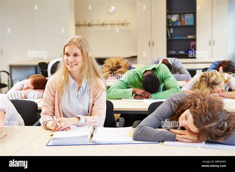 Students Sleeping In School Class And Young Woman Keeping Awake Stock
