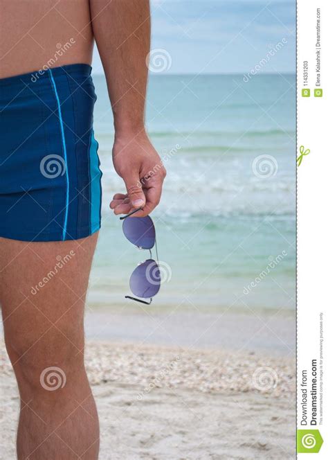 Young Man Stands Against The Sea Shore Beach Sand Waves Water Horizon