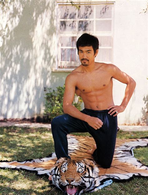 Bruce Lee Posing On A Tiger Carpet Rpics