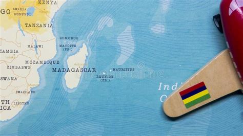 A Map Of Mauritius And A Red Plane With A Flag Of Mauritius Attached To
