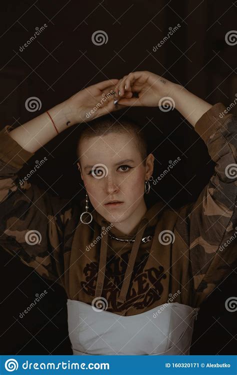 Short Haired Girl In Strange Clothes And Makeup Posing In An Old