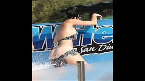 pop diva katy perry loses her bikini bottoms and almost her top after a rough and tumble