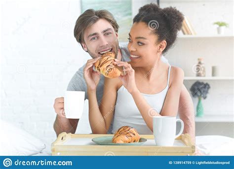 Portrait Of Multiracial Young Couple Having Breakfast In