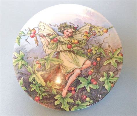 A Plate With An Image Of A Fairy Sitting On A Tree Branch And Holding