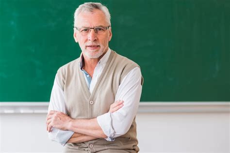 Free Photo Senior Male Teacher With Glasses Against Chalkboard