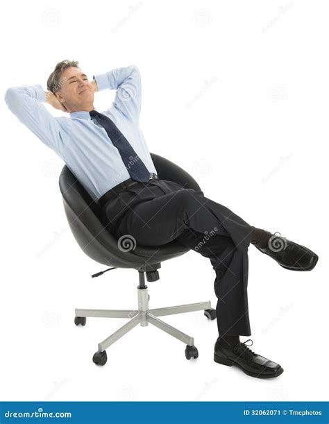 Relaxed Businessman With Hands Behind Head Sitting On Office Chair