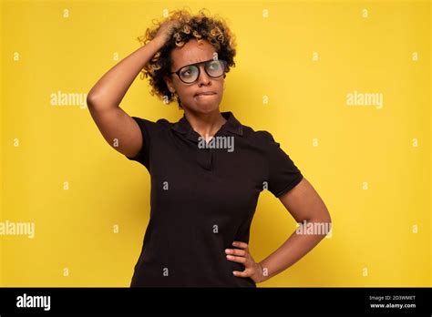 Young African Woman In Glasses Scratching Head Thinking Daydreaming Deeply About Something