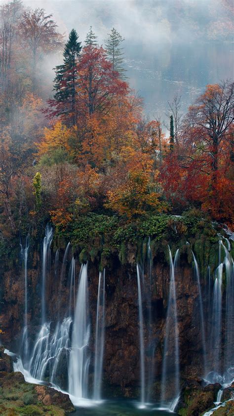Beautiful Waterfalls From Mountains Pouring On River Surrounded By