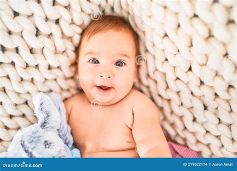Adorable Baby Lying Down Over Blanket On The Sofa Smiling Happy At Home Stock Photo Image Of