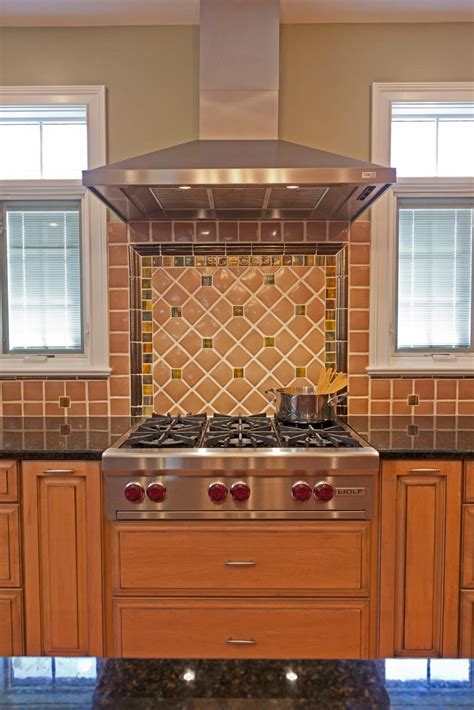 Warm Tile Kitchen Backsplash And Stainless Range Hood Hgtv