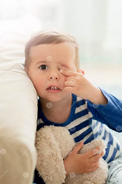 2 Year Old Boy Closing One Eye With His Hand Stock Photo Image Of
