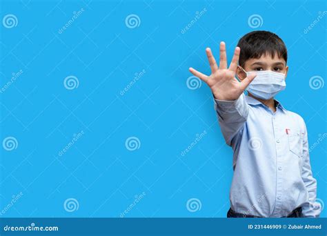 Little Boy Saying Stop With His Hand Isolated On A Plain Background