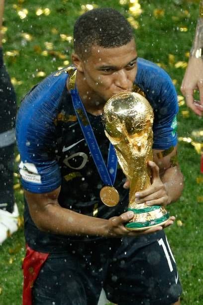 france s forward kylian mbappe kisses the trophy as he celebrates during the trophy ceremony