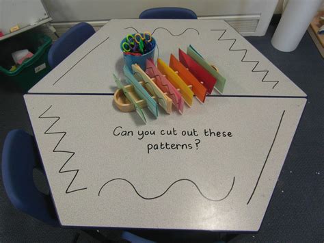 scissor skill provocation on the mark making table. half blank paper ...