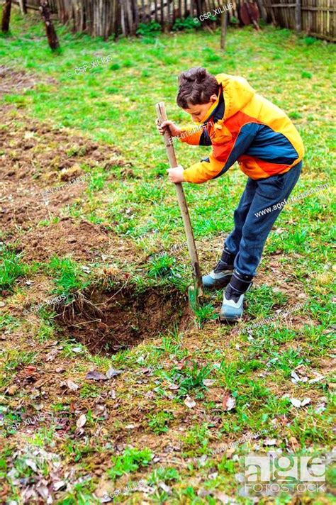 Boy Digging In The Ground Stock Photo Picture And Low Budget Royalty