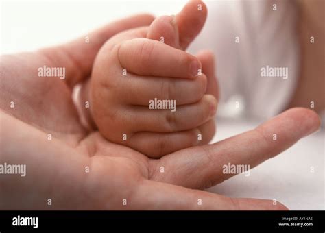Baby Hand Holding Mothers Finger Stock Photo Alamy