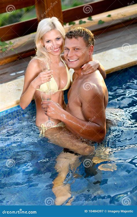 Young Couple Relaxing By The Pool Stock Image Image Of Loving Passion 10484397