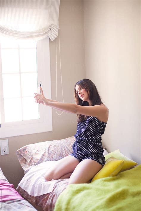 Cute Girl Taking Selfie On Bed By Ohlamour Studio Stocksy United