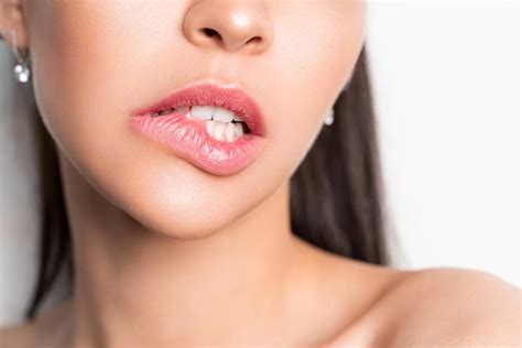 Premium Photo Lip Biting Closeup Of A Young Woman Licking Her Lips Alone On A White Background