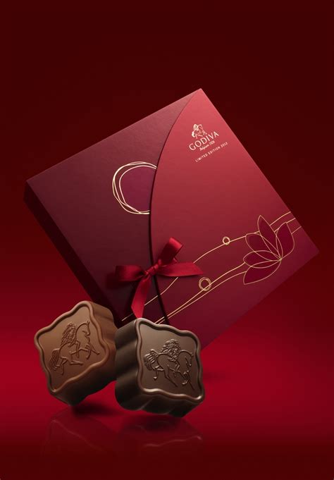 Two Chocolates In Front Of A Red Box