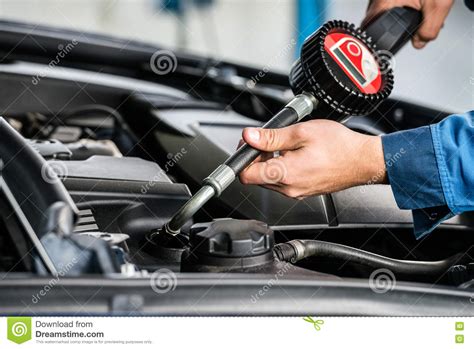 Mechanic Hands Filling Oil Into Car S Engine At Garage Stock Photo