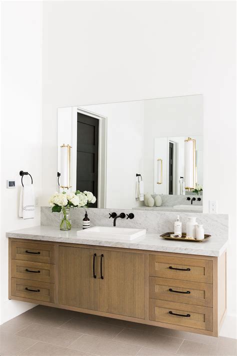 A stylish timber vanity with visible woodgrain (natural. 16 Perfect Marble Bathrooms with Black Fixtures