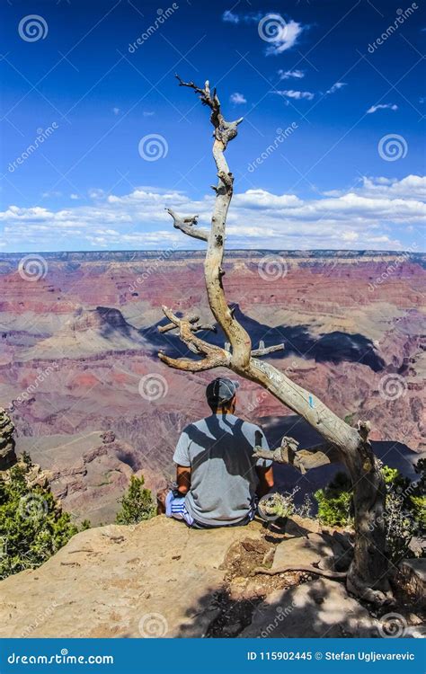 Young Guy Sitting On The Edge Of Grand Canyon Editorial Image Image