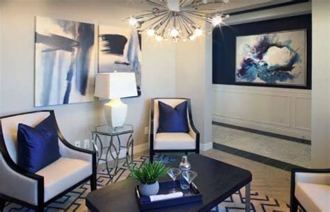 Contemporary Living Room With Modern Chandelier And Navy Blue Accent Wall 550x355 