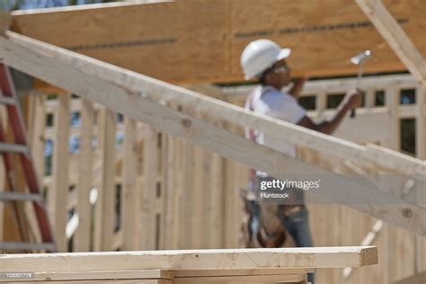 Carpenter Hammering Beam On House Framing High Res Stock Photo Getty