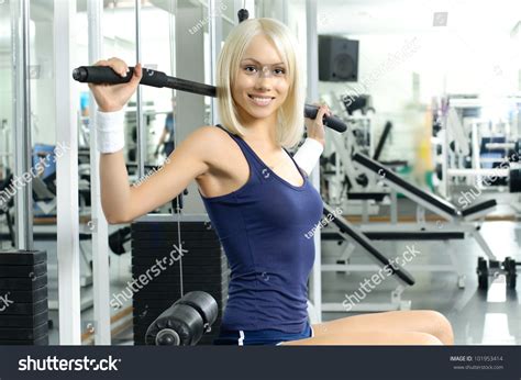 Happy Cutie Athletic Girl Execute Exercise On Sport Apparatus And Smile In Sport Hall Stock