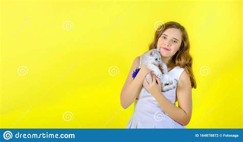 Talk to your friend and write 1st, 2nd or 3rd on the photos. Beautiful Girl On A Yellow Background Holds In Her Arms ...