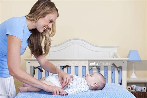 Mother Changing Baby Diaper High Res Stock Photo Getty Images