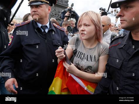 Police Officers Detain A Gay Rights Activist Standing With A Rainbow Flag During A Protest At