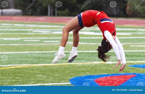 Cheerleader Doing Back Flips On Turf Field Editorial Stock Image