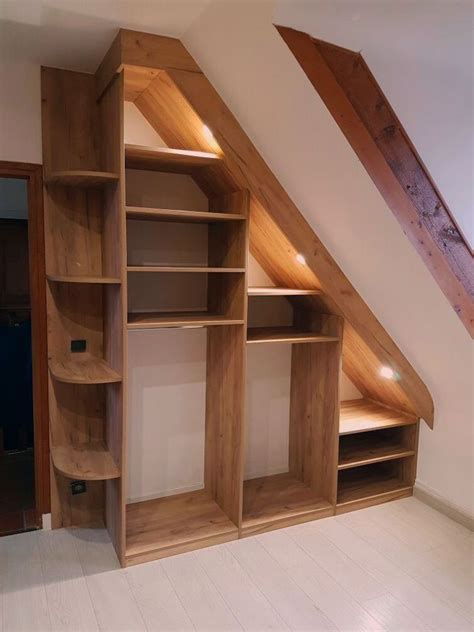 Storage organization under sloped ceiling, attic home office design. Attic Closet Ideas - Walk-in attic storage room features a ...