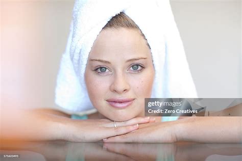 Young Woman Wearing Towel On Head With Chin On Hands High Res Stock