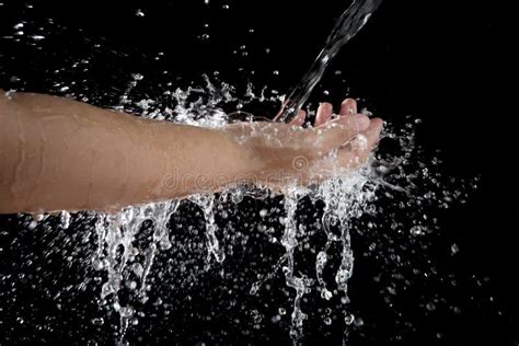 File Of Hand And Pouring Water Splashing On Black Background Stock