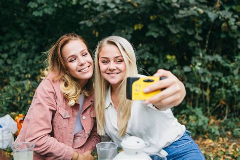 Two Girlfriends Take A Selfie With A Disposable Camera By Stocksy Contributor Kkgas Stocksy