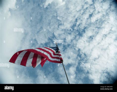 American Flag On A Flagpole Blowing In The Wind Hi Res Stock