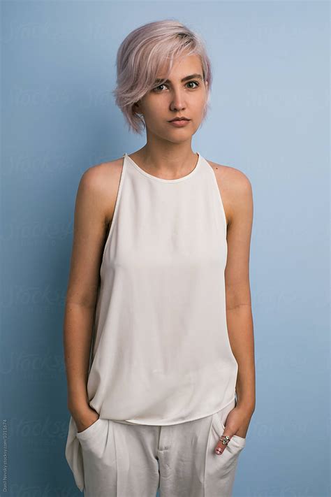 pink haired girl in white against of blue backround by stocksy contributor danil nevsky