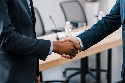 Cropped View Of Businessman Shaking Hands With African American